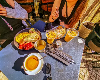 Brunch table with eggs bacon and iced coffee in Lisbon